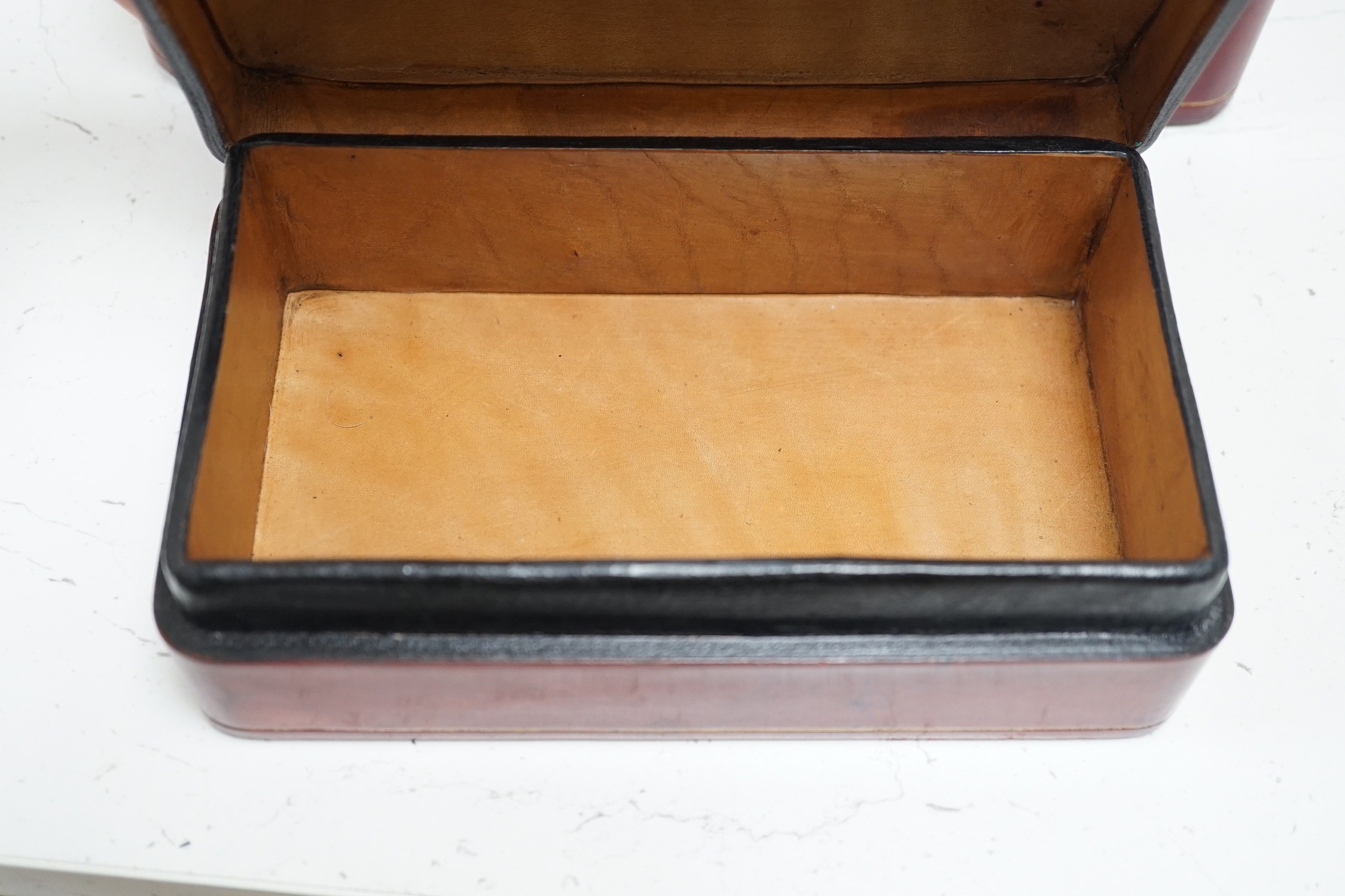 Two red leather boxes, Largest 26.5 cm wide